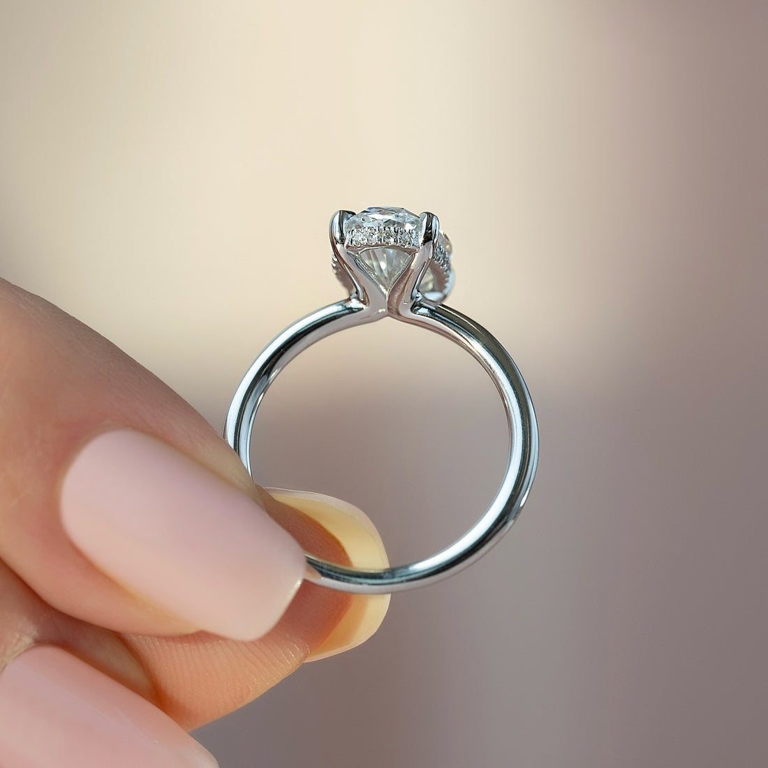 Round brilliant cut lab grown diamond ring with hidden halo on a plain white gold band