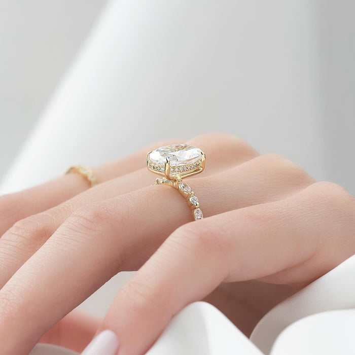 Oval cut lab grown diamond ring in yellow gold with alternating marquise and round accents
