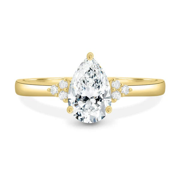 Pear cut lab grown diamond solitaire ring with diamond cluster accents