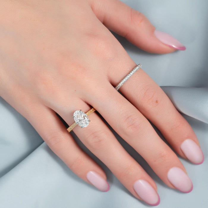 Oval cut lab grown diamond vintage engagement ring worn on the hand