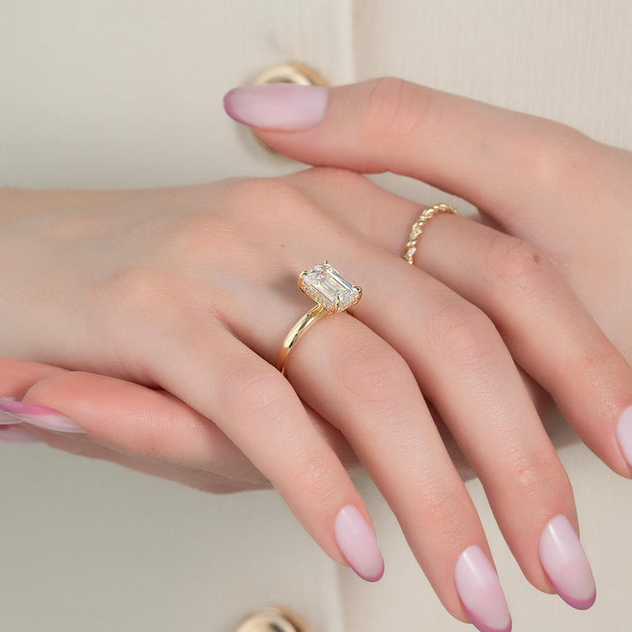 Emerald cut lab grown diamond hidden halo ring worn on the hand