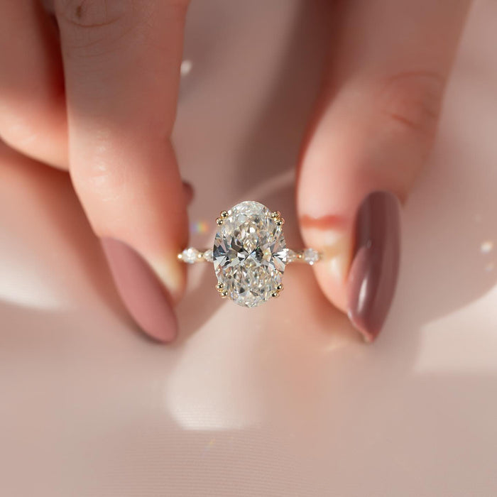 Oval lab grown diamond set sideways with marquise and round accent band