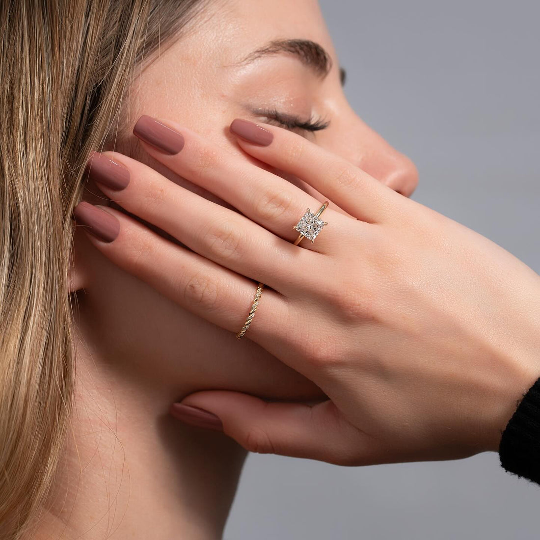 Princess cut lab grown diamond hidden halo ring in yellow gold worn on the hand