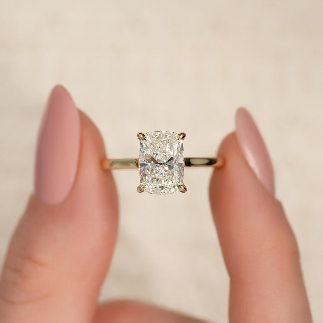 Elongated cushion cut lab grown diamond four claw engagement ring in yellow gold, front view