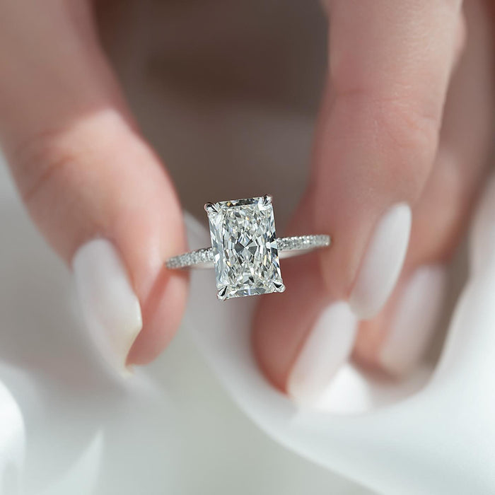 Elongated radiant cut lab grown diamond ring in white gold on a micropave shank