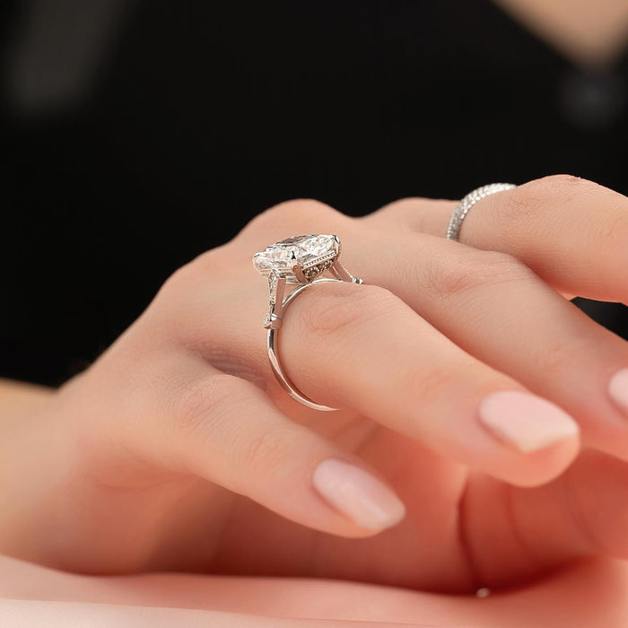 Radiant cut diamond set sideways across the finger in four claws