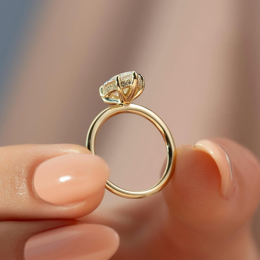 Marquise cut lab grown diamond ring with hidden halo on a plain yellow gold band