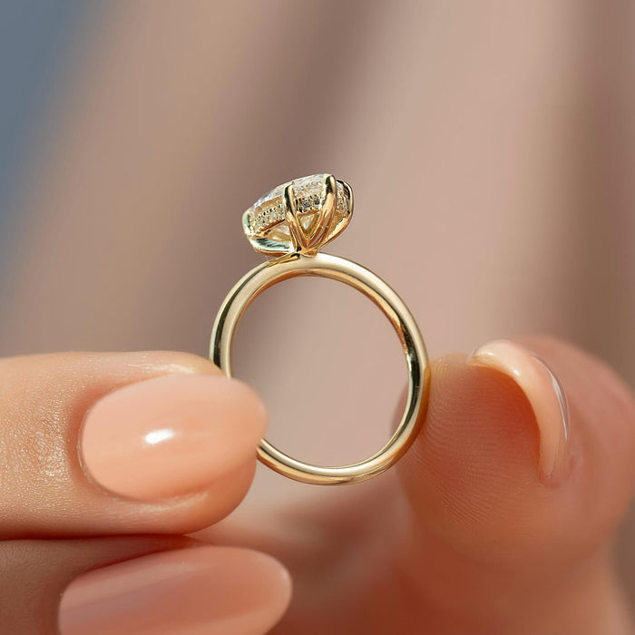 Marquise cut lab grown diamond ring with hidden halo on a plain yellow gold band