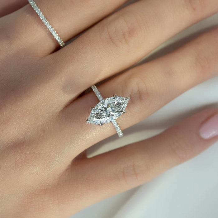 Marquise cut lab grown diamond solitaire ring on a fine pave white gold shank worn on the hand