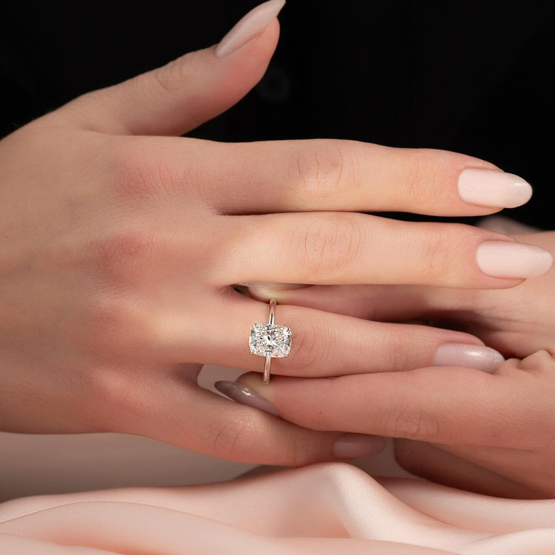 East west elongated cushion lab grown diamond ring on a plain wire band worn on the hand