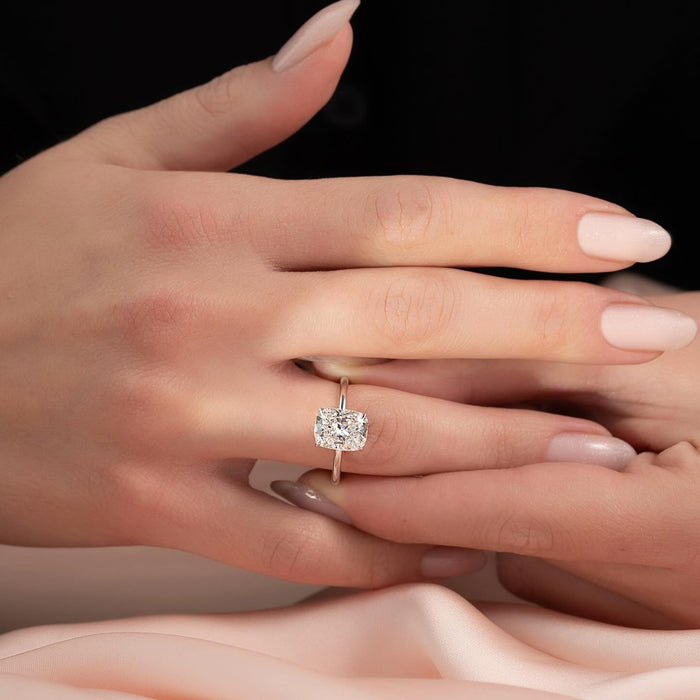 East west elongated cushion lab grown diamond ring on a plain wire band worn on the hand