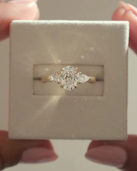 Oval cut lab grown diamond three stone ring with pear side stones