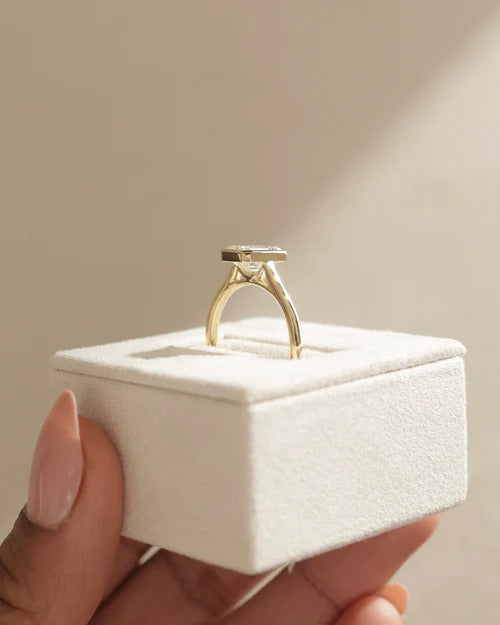 Bezel set emerald cut diamond ring cathedral shoulder profile