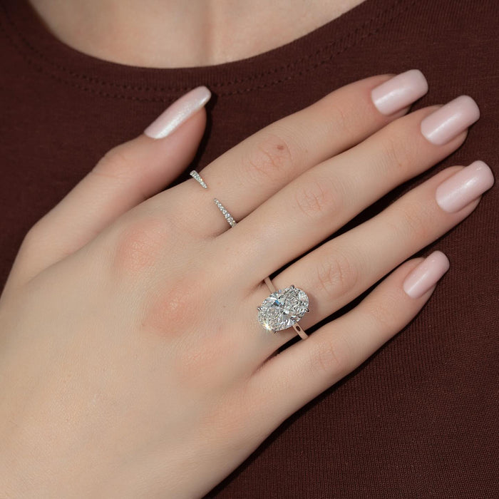Divided shank cushion cut engagement ring worn on the hand
