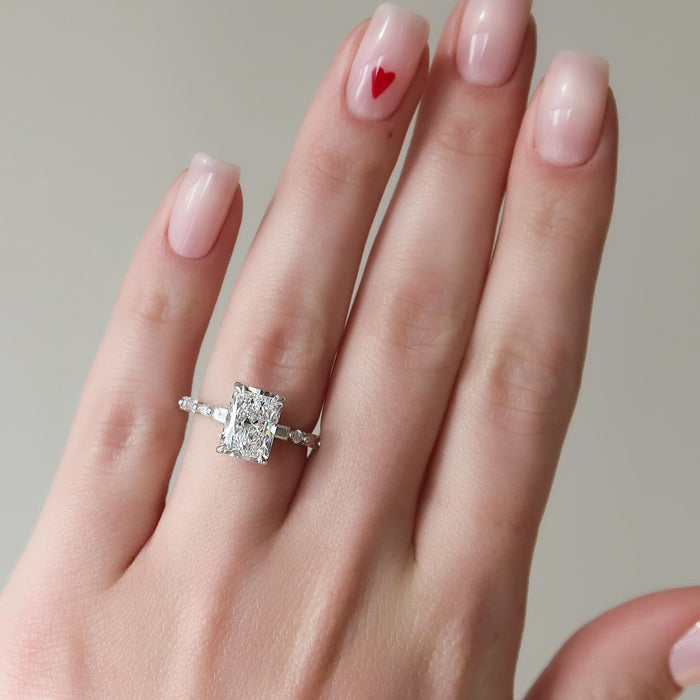 Radiant cut lab grown diamond ring in white gold with a baguette accent on the band