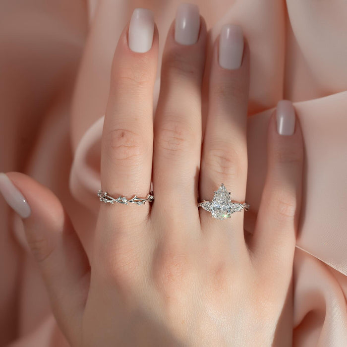 Three stone pear engagement ring worn on the hand