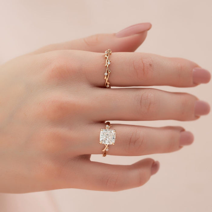 Cushion cut lab grown diamond ring with vine and leaf band in rose gold worn on the hand