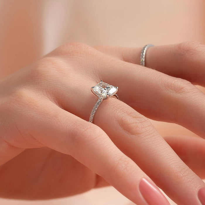 Radiant cut diamond engagement ring with pave band worn on the hand