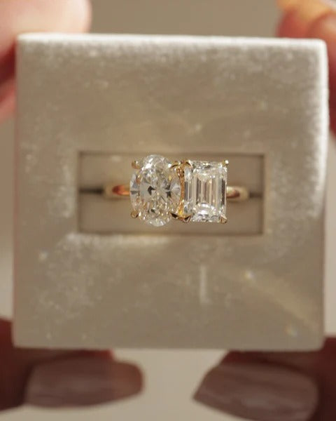 Oval and emerald cut lab grown diamond toi et moi ring on a plain band