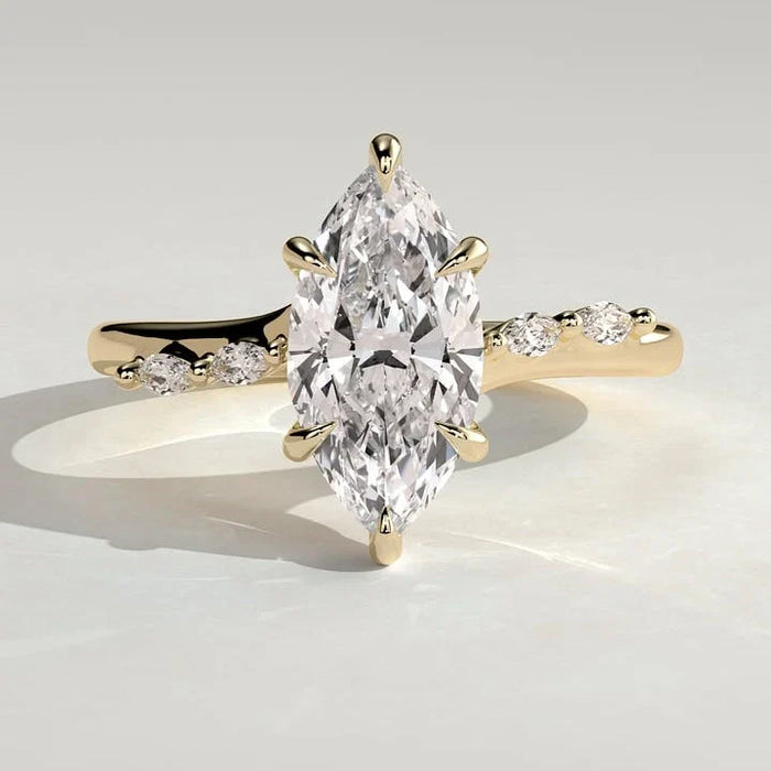 Marquise cut lab grown diamond ring with hidden halo and graduated accents in yellow gold