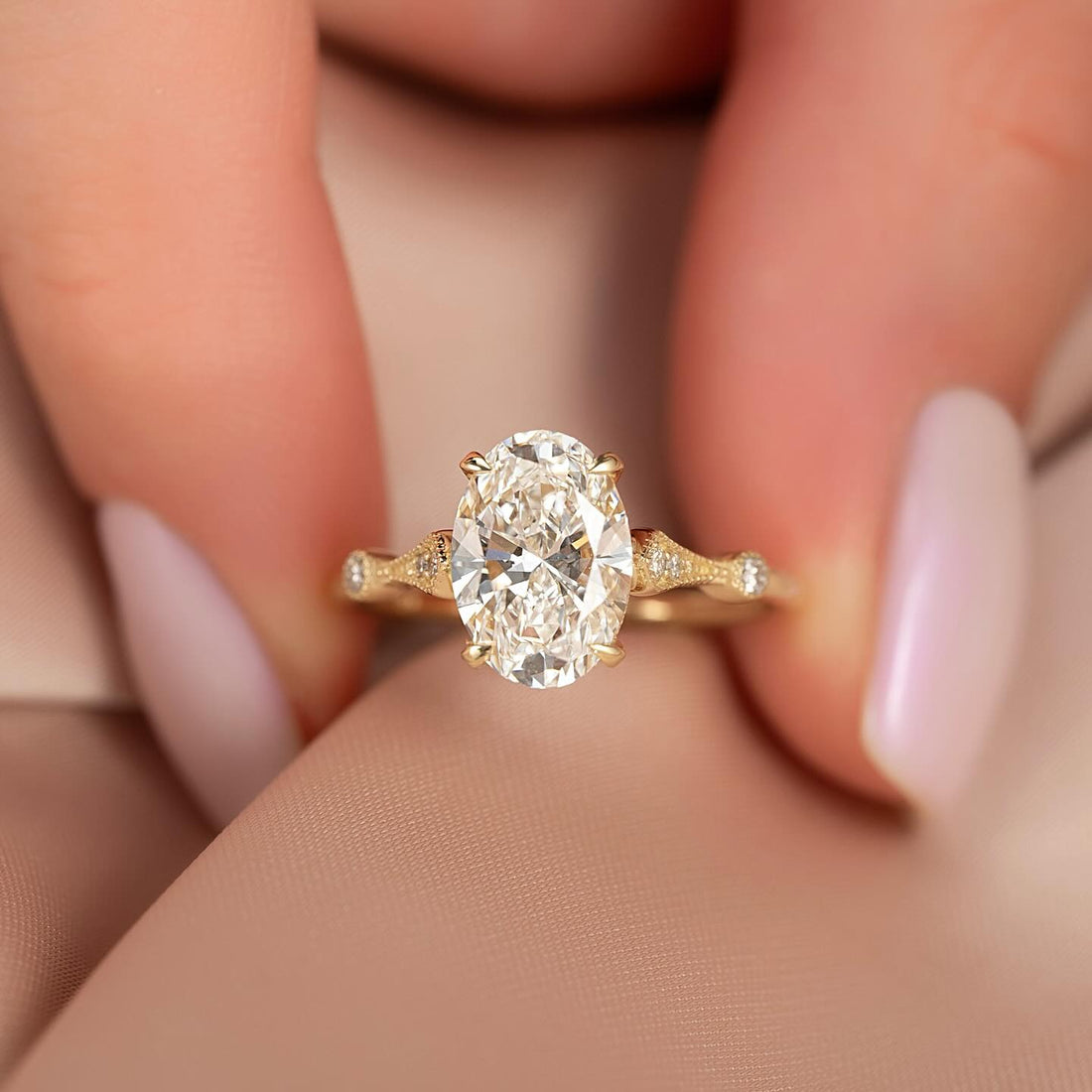 Oval cut lab grown diamond ring with milgrain vintage shoulders in yellow gold