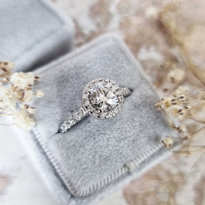 Top view of the round brilliant centre inside a close set diamond halo
