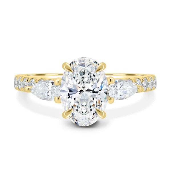 Oval cut lab grown diamond three stone ring with pear sides and pave band