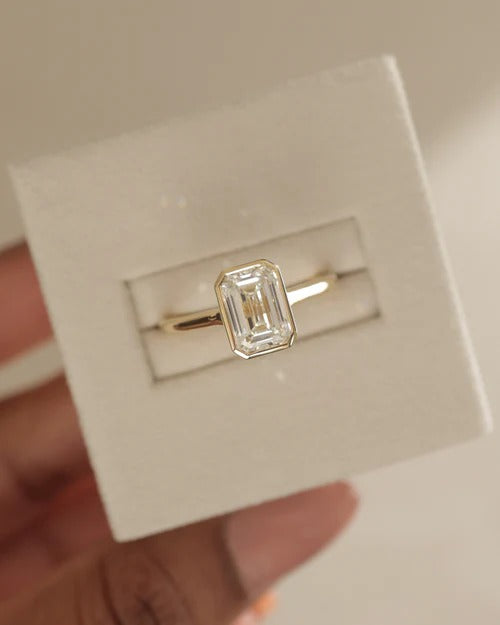 Rub over bezel emerald cut lab grown diamond ring detail