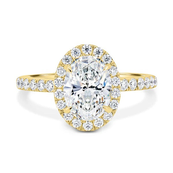 Oval diamond halo engagement ring on hand