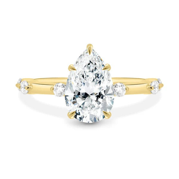 Pear cut lab grown diamond ring with station set side stones
