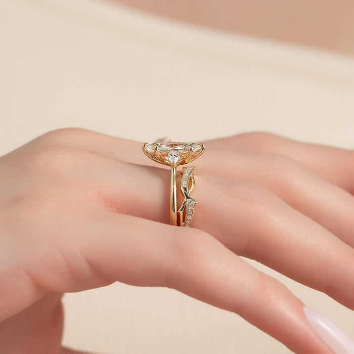 Twisted vine wedding band nestled beneath the marquise engagement ring
