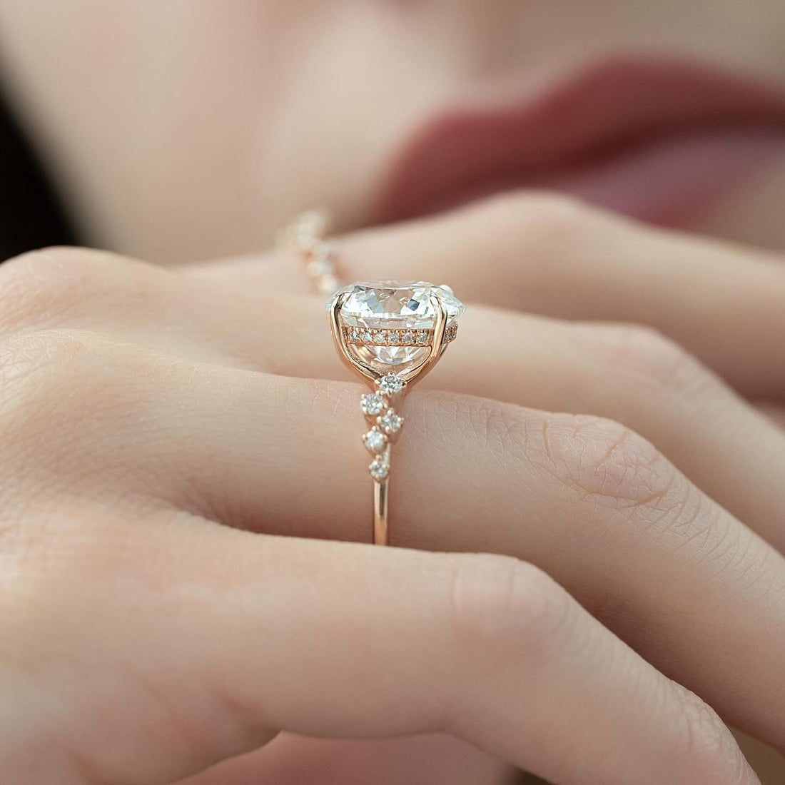 Round brilliant lab grown diamond ring in rose gold with a hidden halo and clustered accents