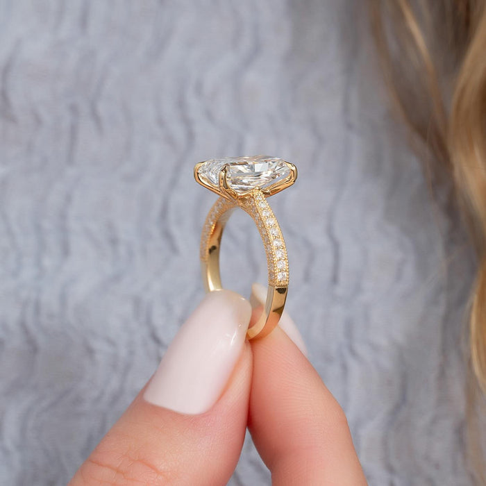 Elongated radiant cut lab grown diamond ring with three sided pave band in yellow gold