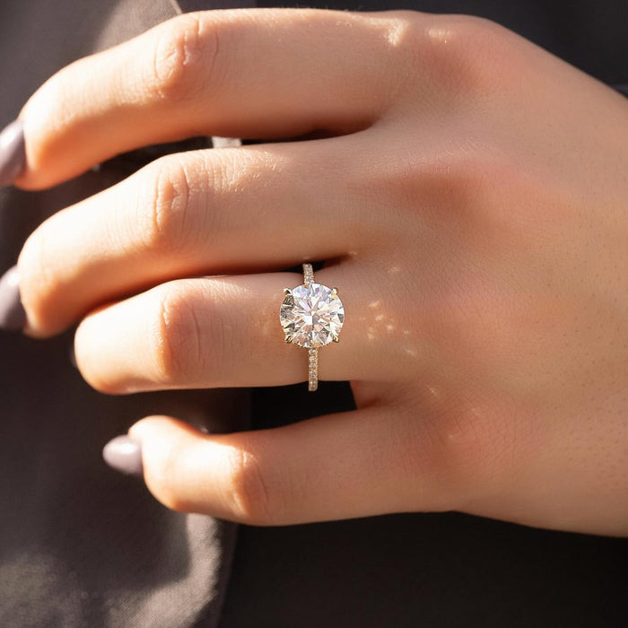 Round lab grown diamond ring with full eternity pave shank in yellow gold worn on hand