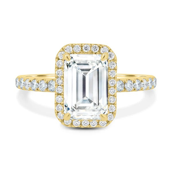 Emerald cut diamond halo engagement ring on hand