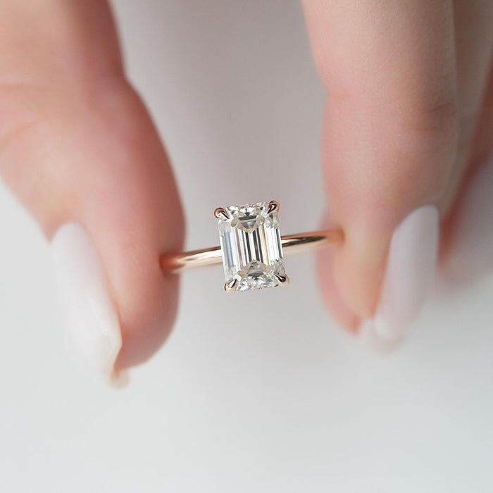 Emerald cut lab grown diamond solitaire ring in rose gold on a slim round band