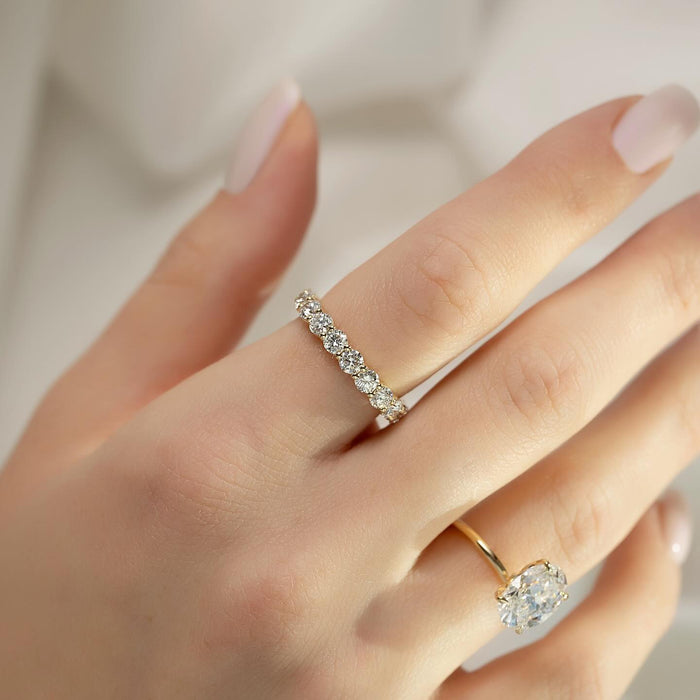 Oval diamond solitaire engagement ring worn on hand