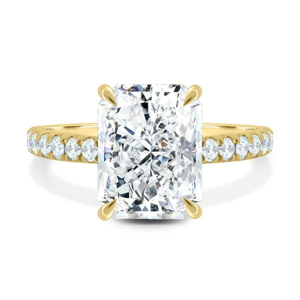 Elongated radiant cut lab grown diamond four claw ring with pave band