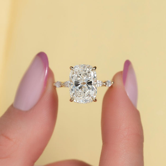 Elongated cushion cut lab grown diamond ring with marquise accent band in yellow gold, front view