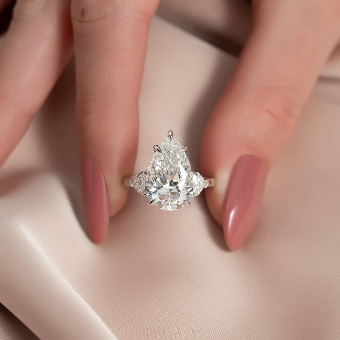 Pear cut lab grown diamond three stone ring with half moon side stones in white gold