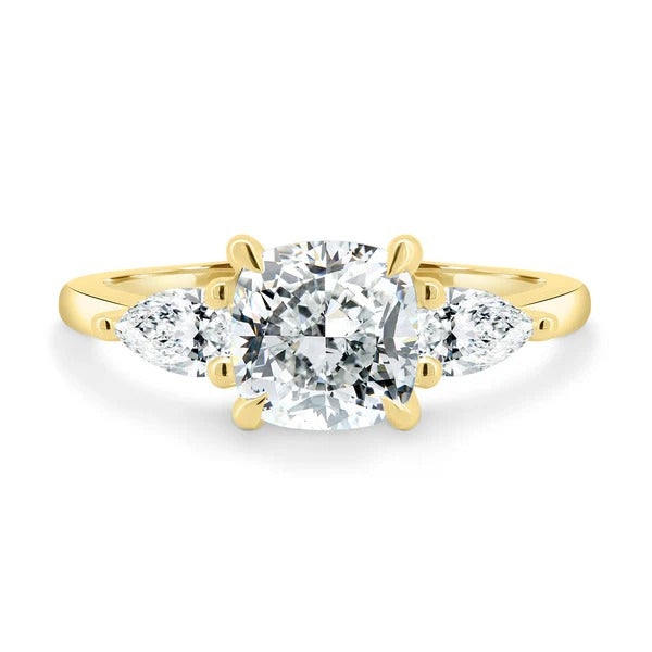 Cushion cut lab grown diamond trilogy ring with pear side stones in a trellis setting