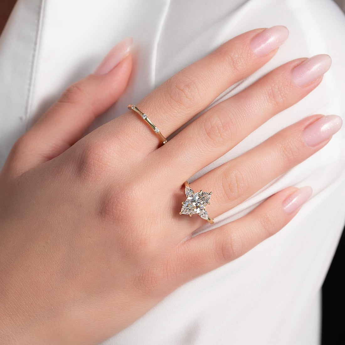 East west marquise lab grown diamond ring with four pear accents in yellow gold