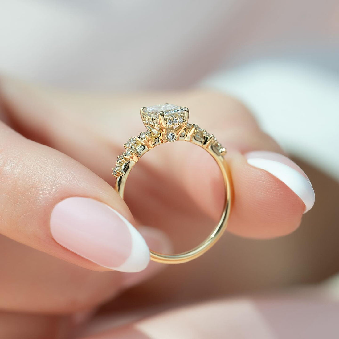 Radiant cut lab grown diamond ring in yellow gold with a concealed halo and graduated accent shoulders