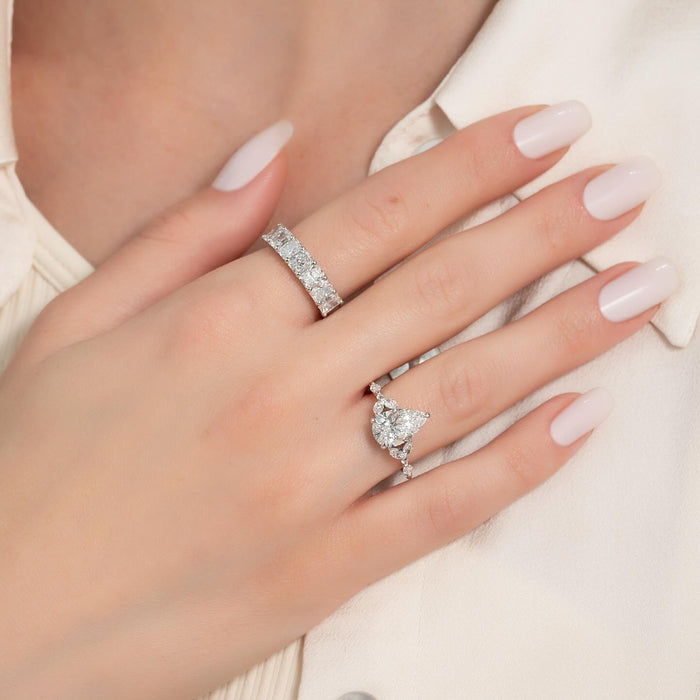 Pear cut lab grown diamond ring with cluster shoulders and marquise accent band in white gold