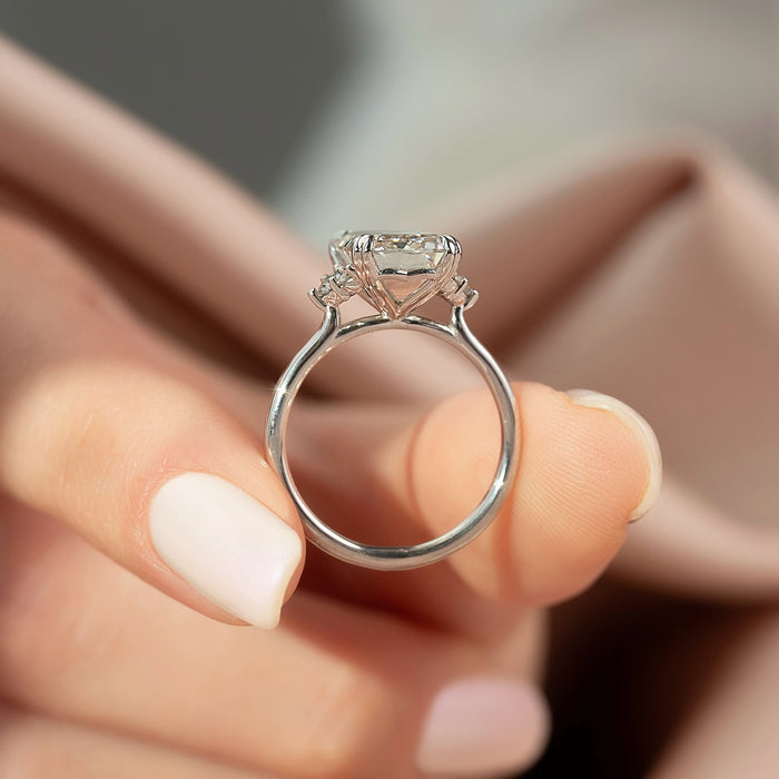 Profile of the emerald cut ring showing the plain shank and corner accents