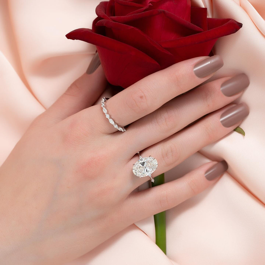Oval cut lab grown diamond solitaire with compass claw setting in white gold worn on the hand