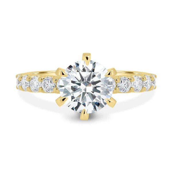 Round cut lab grown diamond six claw ring on a graduated shared prong accent band