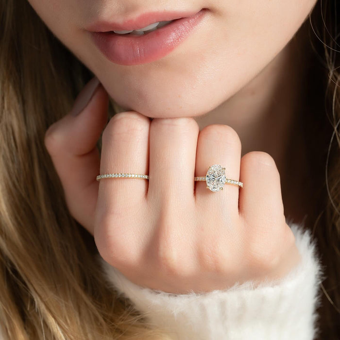 Micro pave shoulders leading up to the oval centre diamond