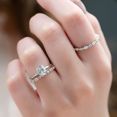 Cushion cut lab grown diamond engagement ring stacked with a baguette accent wedding band in white gold