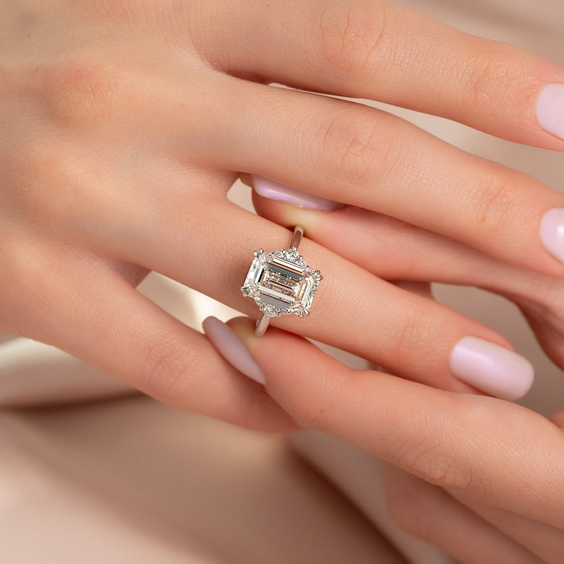 Emerald cut lab grown diamond ring with corner diamond clusters in white gold
